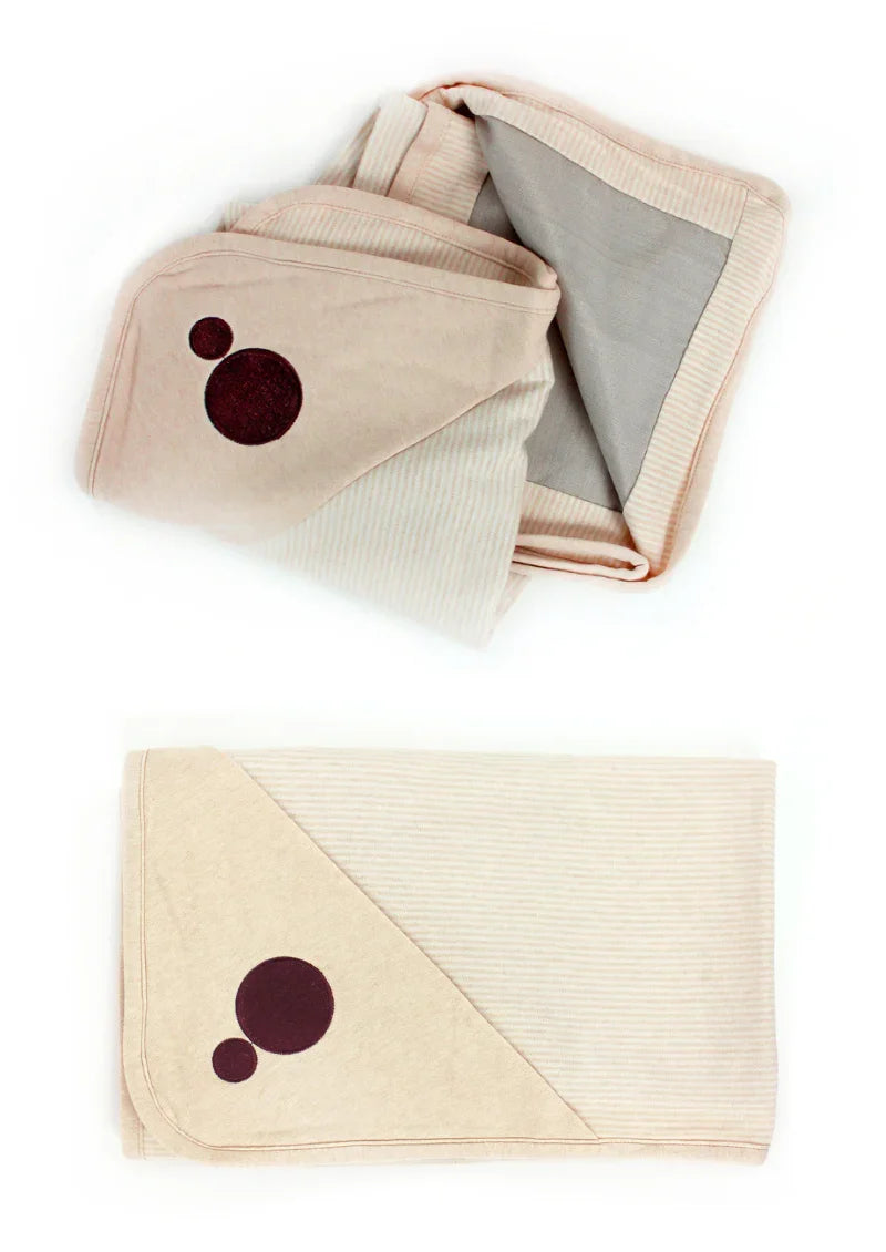 Folded Belly Armor organic cotton belly blankets showing embroidered logo and lining