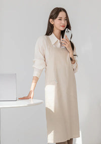 Woman wearing a beige Belly Armor linen EMF protection apron while using her phone