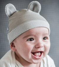 Baby wearing a gray Belly Armor organic cotton EMF protection hat with rounded ears