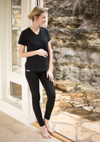 Pregnant woman wearing a black Belly Armor EMF protection maternity tee outdoors